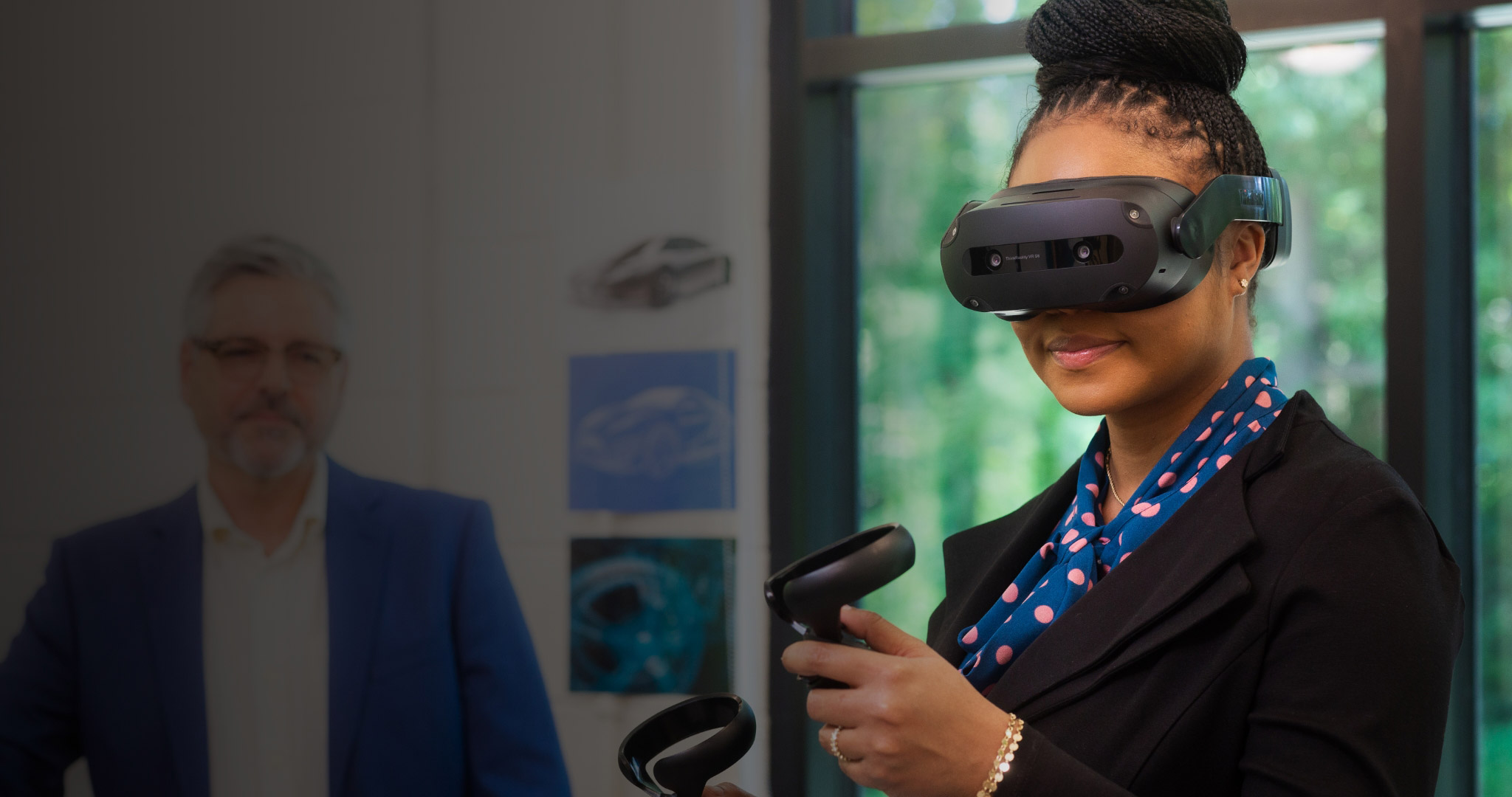 A woman using a VR headset and controllers in an office